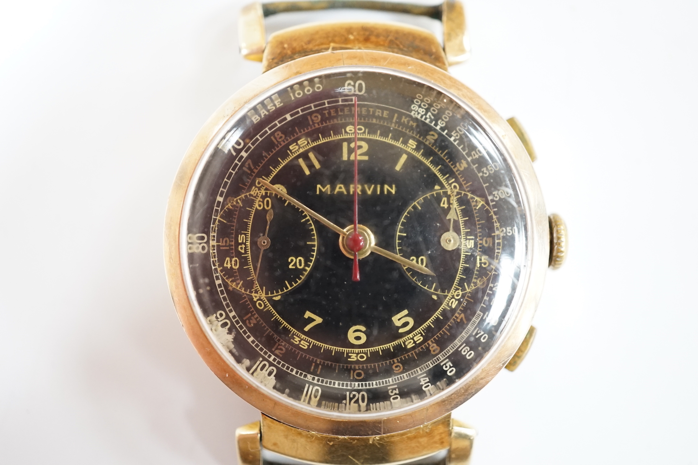 A gentleman's gilt metal Marvin chronograph manual wind black dial wrist watch, no strap, case diameter 36mm.